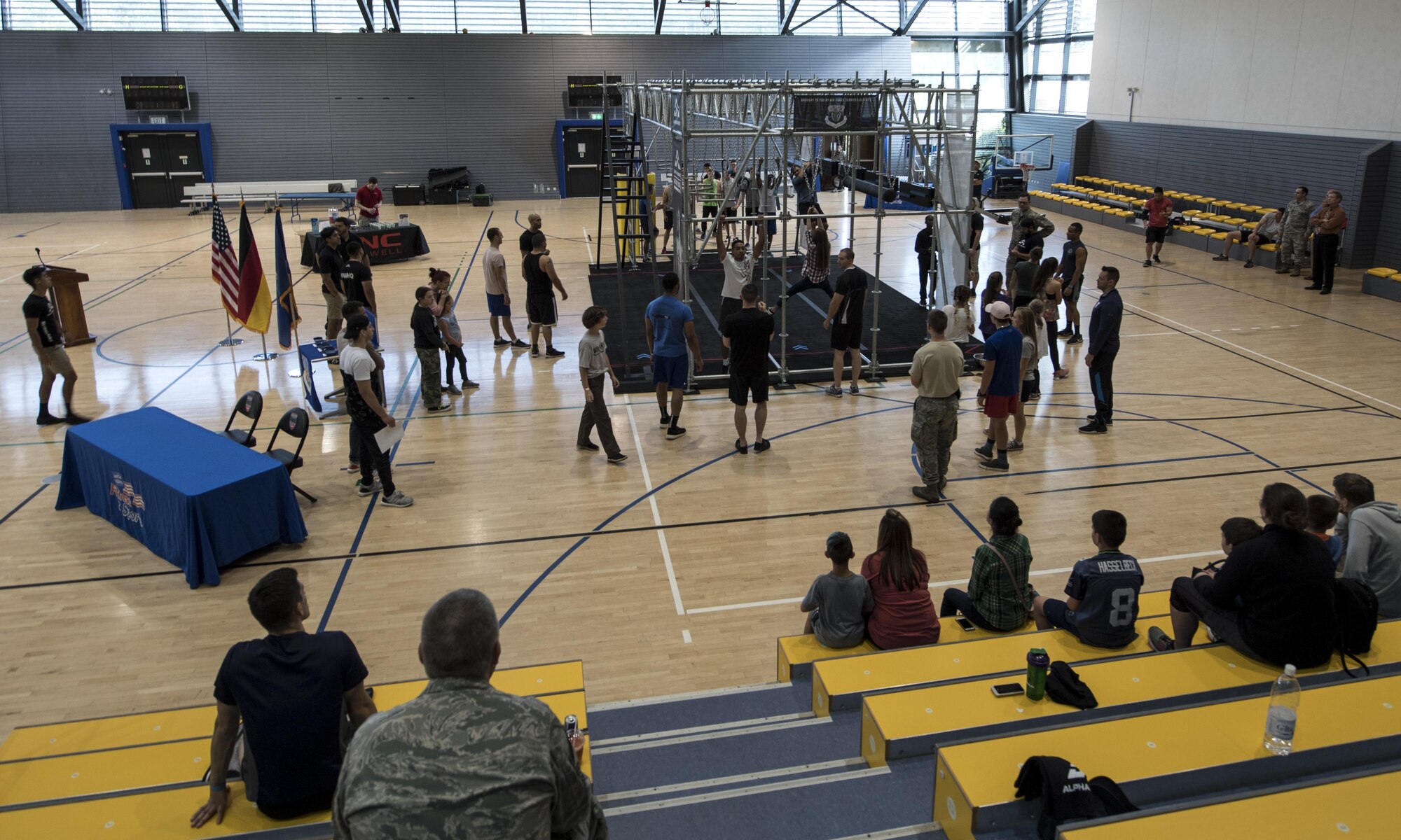 Kaiserslautern Military Community members watch and participate in practicing on the Alpha Warrior’s Battle Rig obstacle course during the Alpha Warrior Tour on Ramstein Air Base, Germany, Sept. 22, 2017. During the tour, Alpha Warrior pros Barclay Stockett, Karsten Williams, and Kevin Klein taught Airmen the best techniques for successfully completing the course. (U.S. Air Force photo by Senior Airman Tryphena Mayhugh)