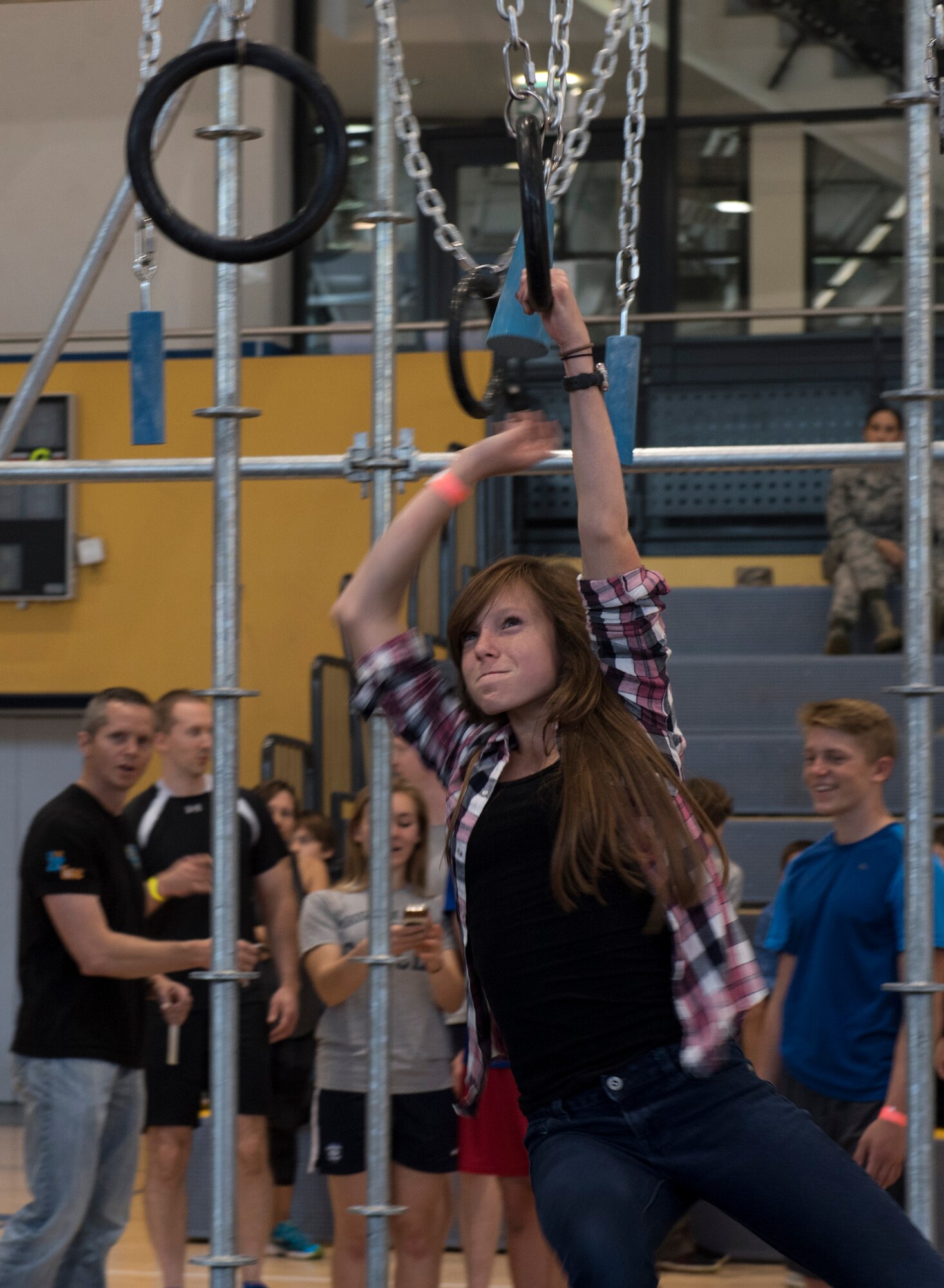 A young girl swings to reach another hand hold on the Alpha Warrior’s Battle Rig obstacle course during the Alpha Warrior Meet/Greet and Familiarization Tour on Ramstein Air Base, Germany, Sept. 22, 2017. During the first day of the tour, any Department of Defense card holder 13 years or older could practice on the obstacle course before the Alpha Warrior local and regional competitions were held. (U.S. Air Force photo by Senior Airman Tryphena Mayhugh)