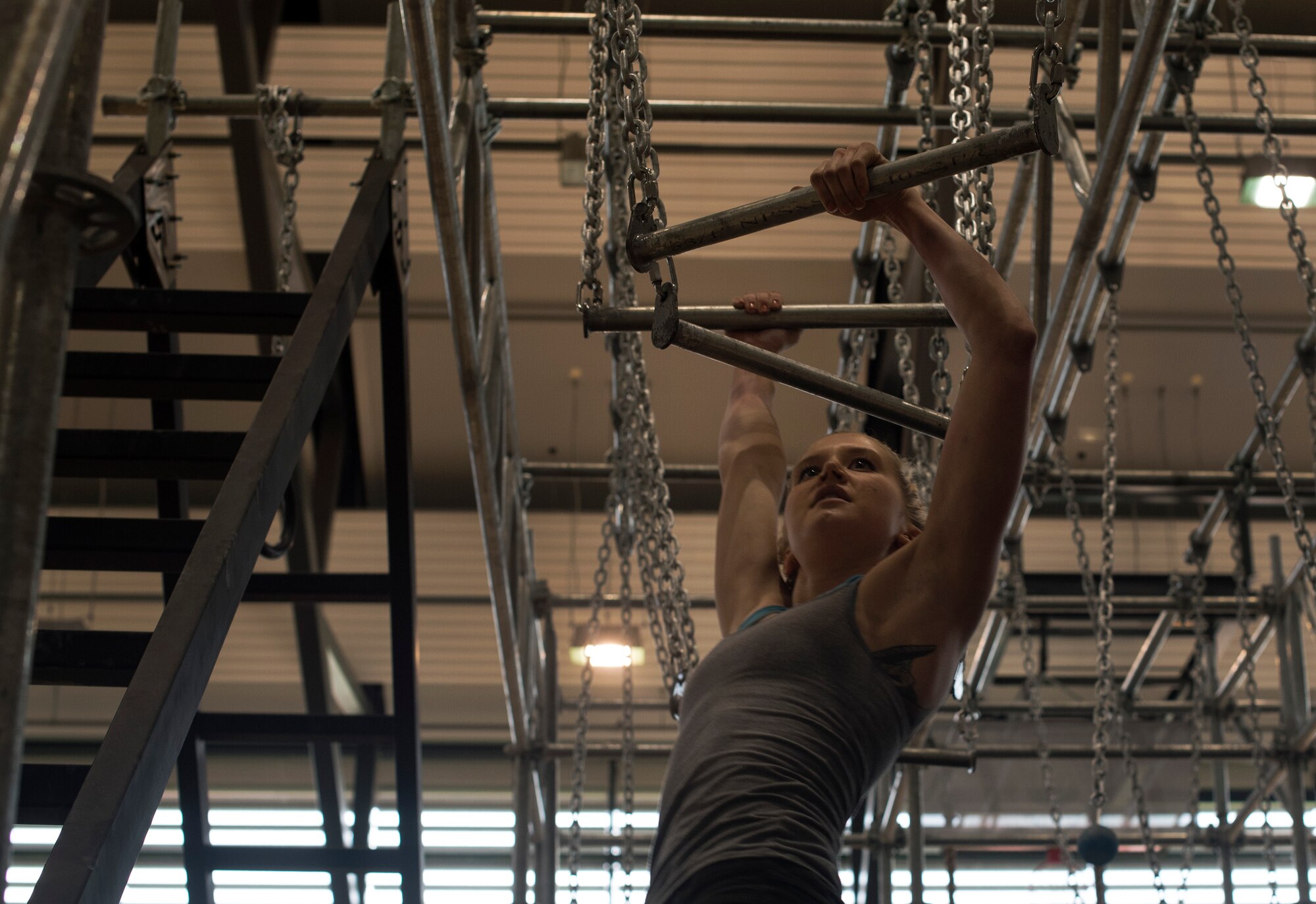 U.S. Air Force Staff Sgt. Brina Rustand, 86th Munitions Squadron munitions inspector, grips two uneven bars in the Alpha Warrior’s Battle Rig obstacle course during the Alpha Warrior regional competition on Ramstein Air Base, Germany, Sept. 23, 2017. The competition was part of the Alpha Warrior Tour, and the obstacle course will remain at Ramstein as another option for Airmen to use to stay on top of their physical fitness. (U.S. Air Force photo by Senior Airman Tryphena Mayhugh)