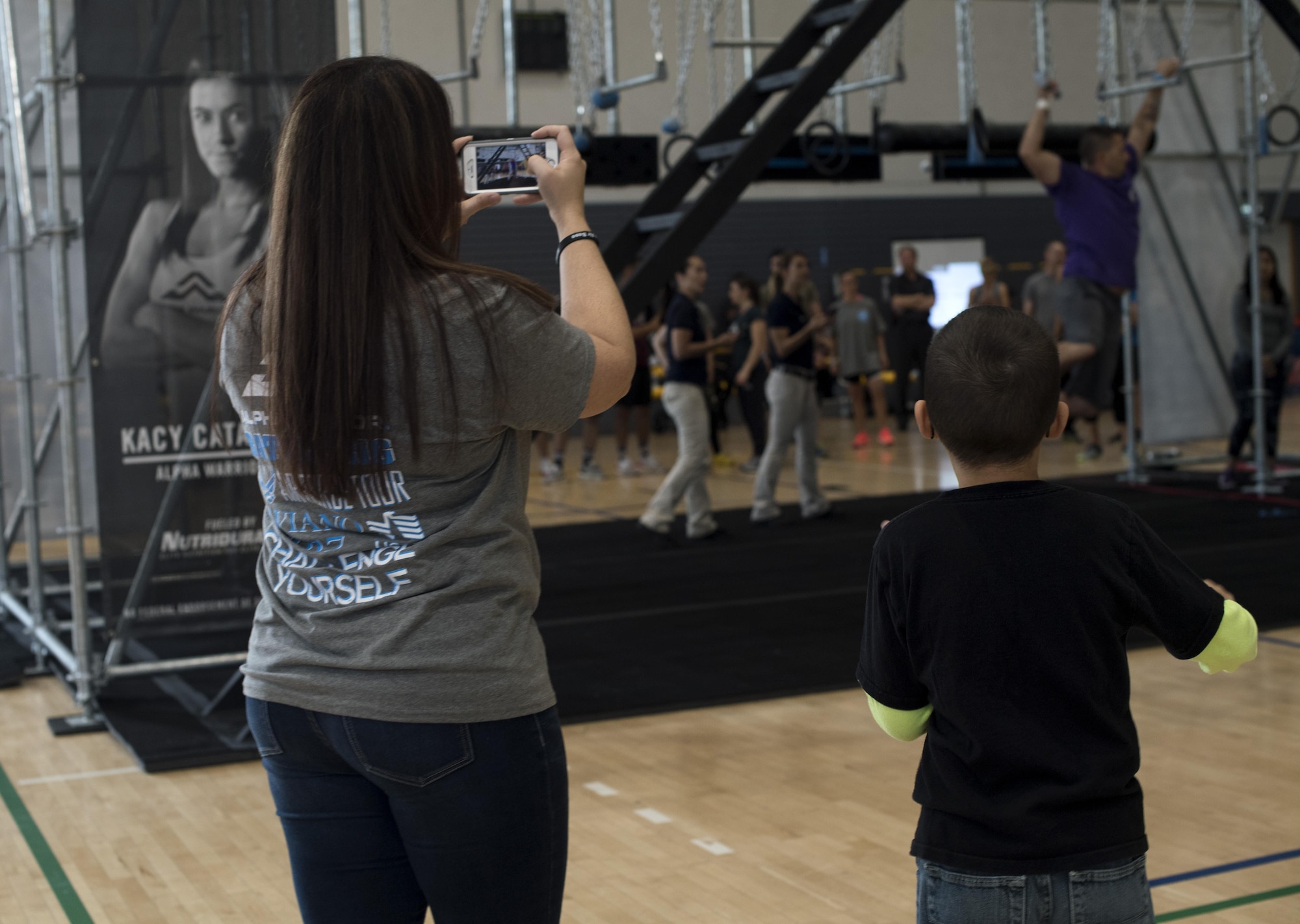 U.S. Air Force Master Sgt. Wallace Fortier, 31st Aircraft Maintenance Squadron weapons section chief, participates in the Alpha Warrior regional competition while his wife and son cheer for him on Ramstein Air Base, Germany, Sept. 23, 2017. The competition was part of the Alpha Warrior Tour, which included Alpha Warrior pros Barclay Stockett, Karsten Williams, and Kevin Klein. (U.S. Air Force photo by Senior Airman Tryphena Mayhugh)