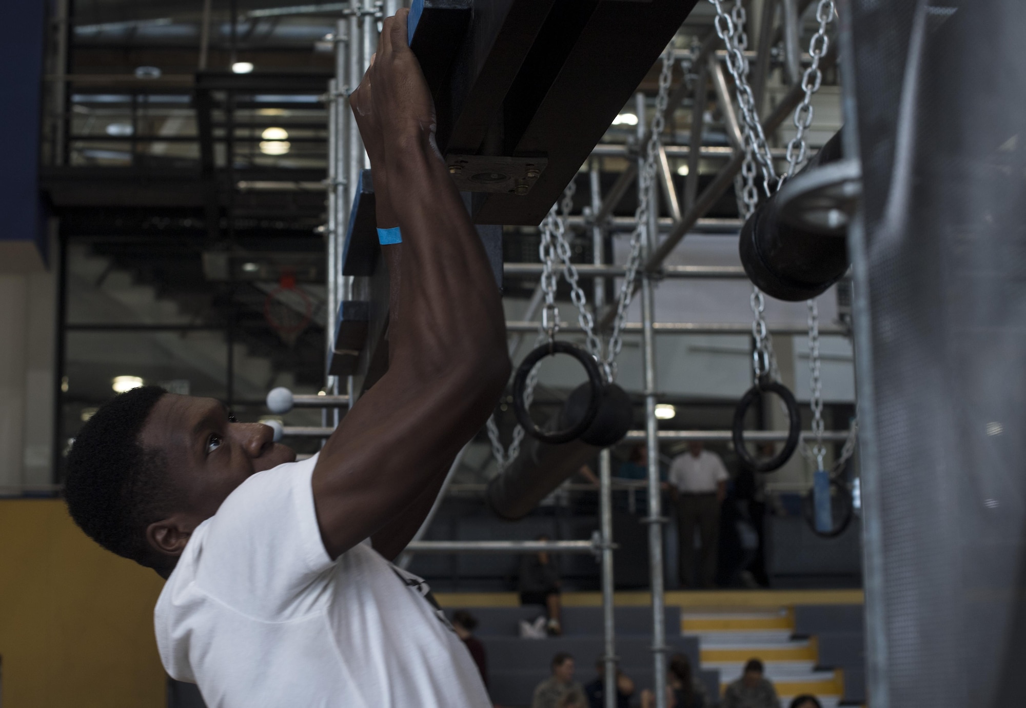 U.S. Army Sgt. Justin Paige, 57th Air Defense Artillery culinary specialist, grips the cliff hanger section of the Alpha Warrior’s Battle Rig obstacle course during the Alpha Warrior regional competition on Ramstein Air Base, Germany, Sept. 23, 2017. Over 30 service members participated in the competition for the chance to move on to the championship. (U.S. Air Force photo by Senior Airman Tryphena Mayhugh)