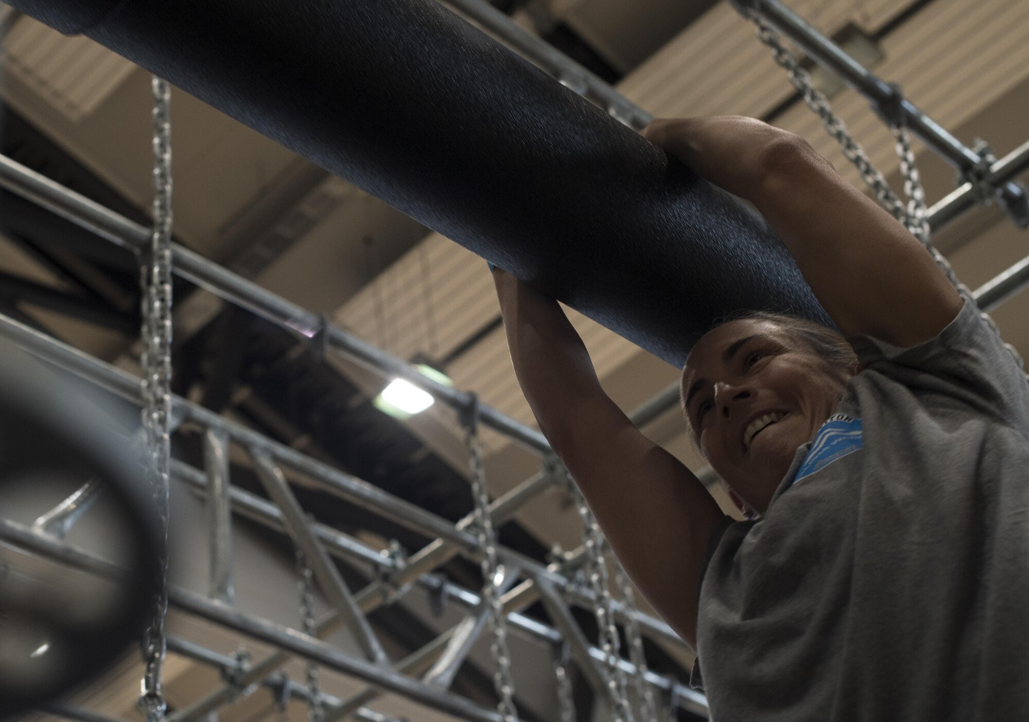 U.S. Air Force Senior Master Sgt. Elizabeth Olson, 31st Logistics Readiness Squadron logistics operations superintendent, hangs from a battering ram while competing on the Alpha Warrior’s Battle Rig obstacle course during the Alpha Warrior regional competition on Ramstein Air Base, Germany, Sept. 23, 2017. Airmen from Ramstein and Aviano Air Base, Italy, competed against one another for the chance to move on to the championship in San Antonio, Texas. (U.S. Air Force photo by Senior Airman Tryphena Mayhugh)