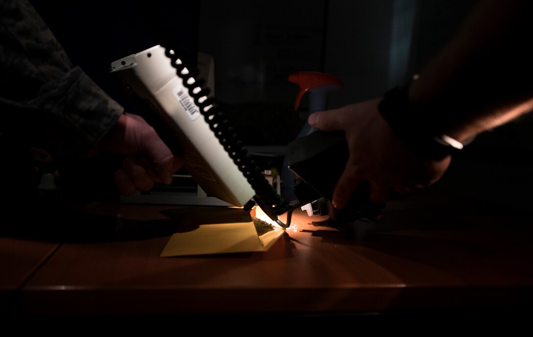 U.S. Air Force Tech. Sgt. Jacob Sargent, 786th Civil Engineer Squadron noncommissioned officer in charge of emergency management standards and evaluations (left), and U.S. Air Force Senior Airman Benjamin Thompson, 786th CES emergency management and operations specialist, use multiple pieces of equipment to identify a simulated suspicious white powder during the 786 CEG Prime Base Engineer Emergency Force training day on Ramstein Air Base, Germany, Sept. 21, 2017. Prime BEEF holds a training day once a month to prepare 786th and 86th CES Airmen for what they will need to know when they are in an austere location. (U.S. Air Force photo by Senior Airman Tryphena Mayhugh)