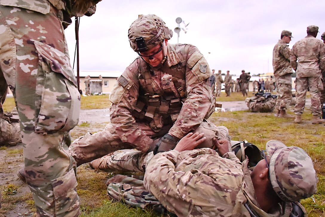 Pvt. Brady Barrett provides medical aid to a mock casualty during the Expert Infantryman Badge competition.