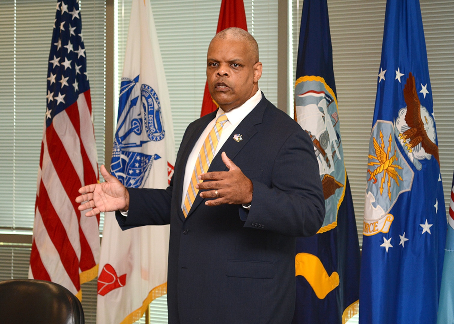Retired Navy Rear Adm. Sinclair Harris speaks to DLA Energy employees