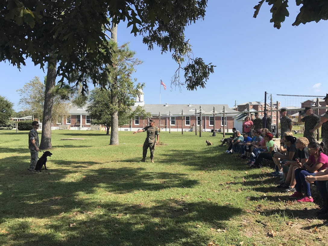 On September 22, 2017 as part of Better Half Day, Military Working Dog (MWD) handlers and their dogs provided demonstrations on:  obedience, explosives detection, tracking, and attack capabilities. The spouses and Marines learn about MWD history and meet one of the dogs.