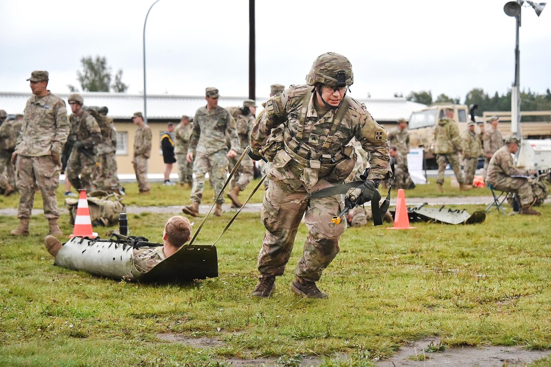 Sgt. John Messick pulls mock casualty in a sked litter during the Expert Infantryman Badge competition.