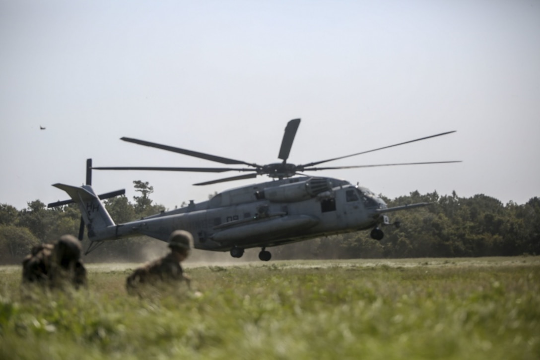 Marines wait for a helicopter to land as part of a reconnaissance mission during a field training exercise at Camp Lejeune, N.C., Sept. 17-21, 2017. The field exercise prepares Marines for future deployments though events including engineer reconnaissance, helicopter operations, improvised explosive device lanes with route clearing courses, survivability tasks, breeching, and urban operations. The Marines are with 2nd Combat Engineer Battalion. (U.S. Marine Corps photo by Lance Cpl. Gloria Lepko)