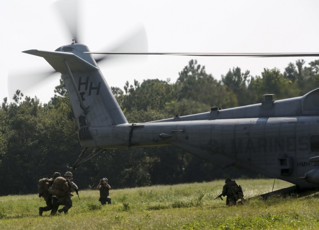 Marines rush to enter a helicopter as part of a reconnaissance mission during a field training exercise at Camp Lejeune, N.C., Sept. 17-21, 2017. The field exercise prepares Marines for future deployments though events including engineer reconnaissance, helicopter operations, improvised explosive device lanes with route clearing courses, survivability tasks, breeching, and urban operations. The Marines are with 2nd Combat Engineer Battalion Alpha, Bravo, and Charlie Companies. (U.S. Marine Corps photo by Lance Cpl. Gloria Lepko)