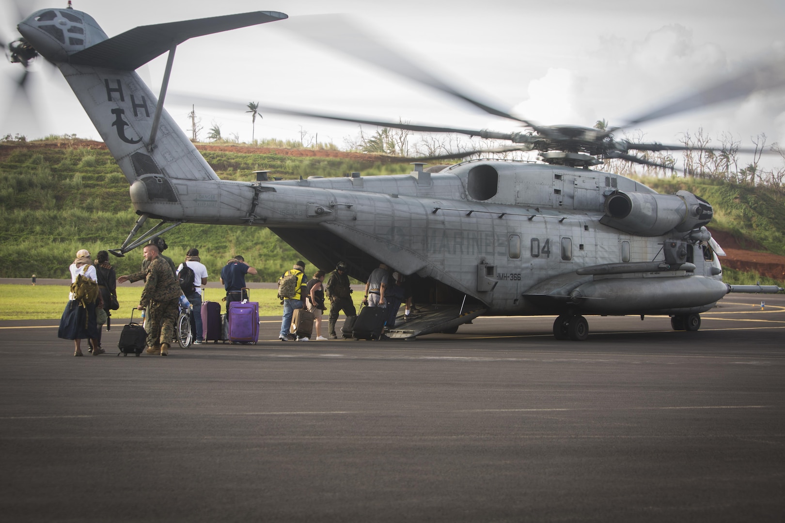 U.S. citizens board a U.S. Marine CH-53E Super Stallion helicopter with Joint Task Force - Leeward Islands at Douglas-Charles Airport in Dominica, Sept. 24, 2017.