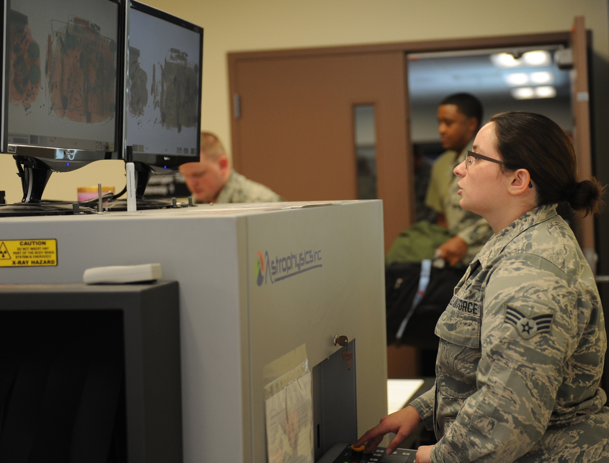 An Airman examines baggage content