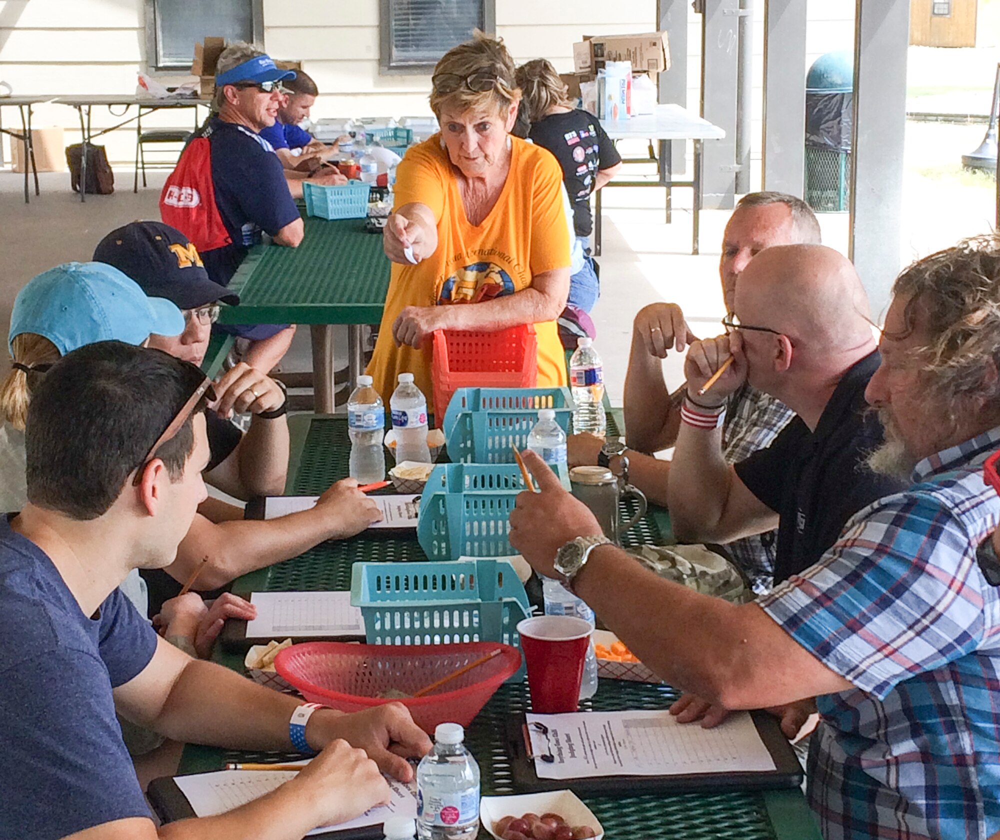 Laura Coad, Chili Cook-Off coordinator, provides instruction to the judges for the “Anything Goes” category during the Ruckus at the Rec Camp at the Goodfellow Air Force Base Recreation Camp, San Angelo, Texas, Sept. 23, 2017. The competition included categories for teams and individuals in the Terlingua, chicken, ribs, beans and "anything goes" category. (U.S. Air Force photo by Aryn Lockhart/Released)