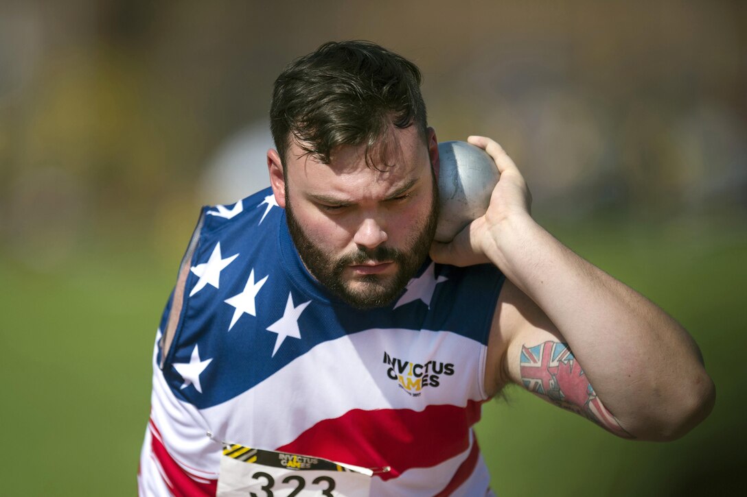 Air Force Senior Airman Lucas Purser prepares to throw the shot put.