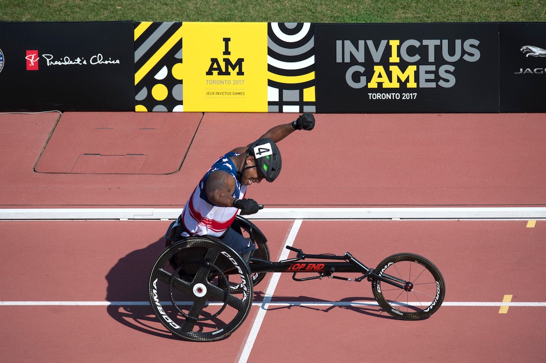 Army Staff Sgt. Ryan Major reacts to finishing a wheelchair race.