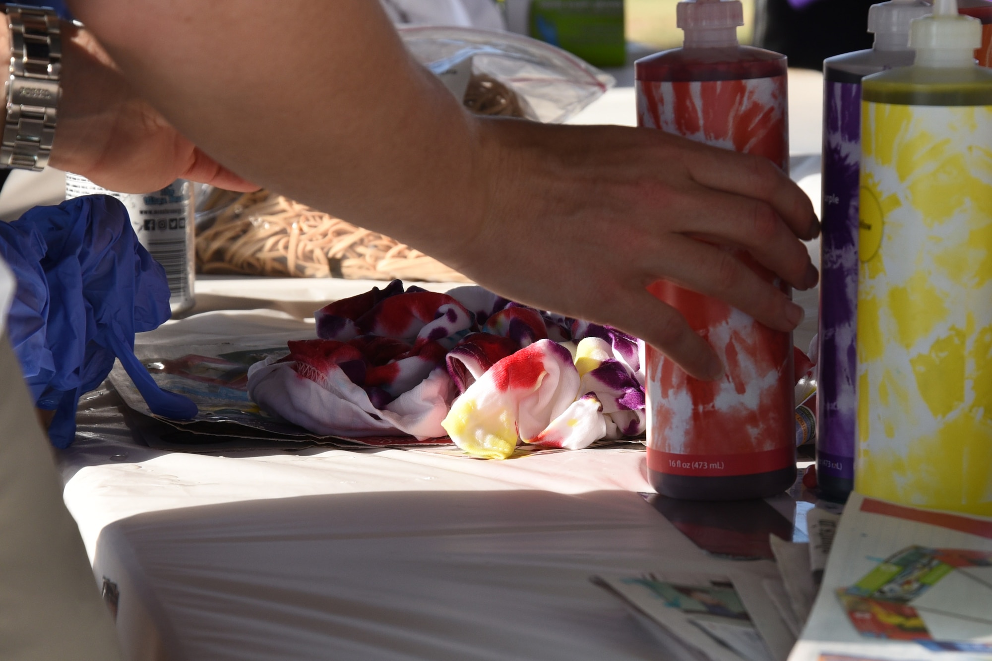 An Airman chooses colors for their tie-dye shirt during the event to die for at the marching pad on Goodfellow Air Force Base, Texas, Sept. 22, 2017. While the Airmen were meeting and greeting they also had the chance to learn from the noncommissioned officers about their personal experiences and about their special duties. (U.S. Air Force photo by Airman Zachary Chapman/Released)