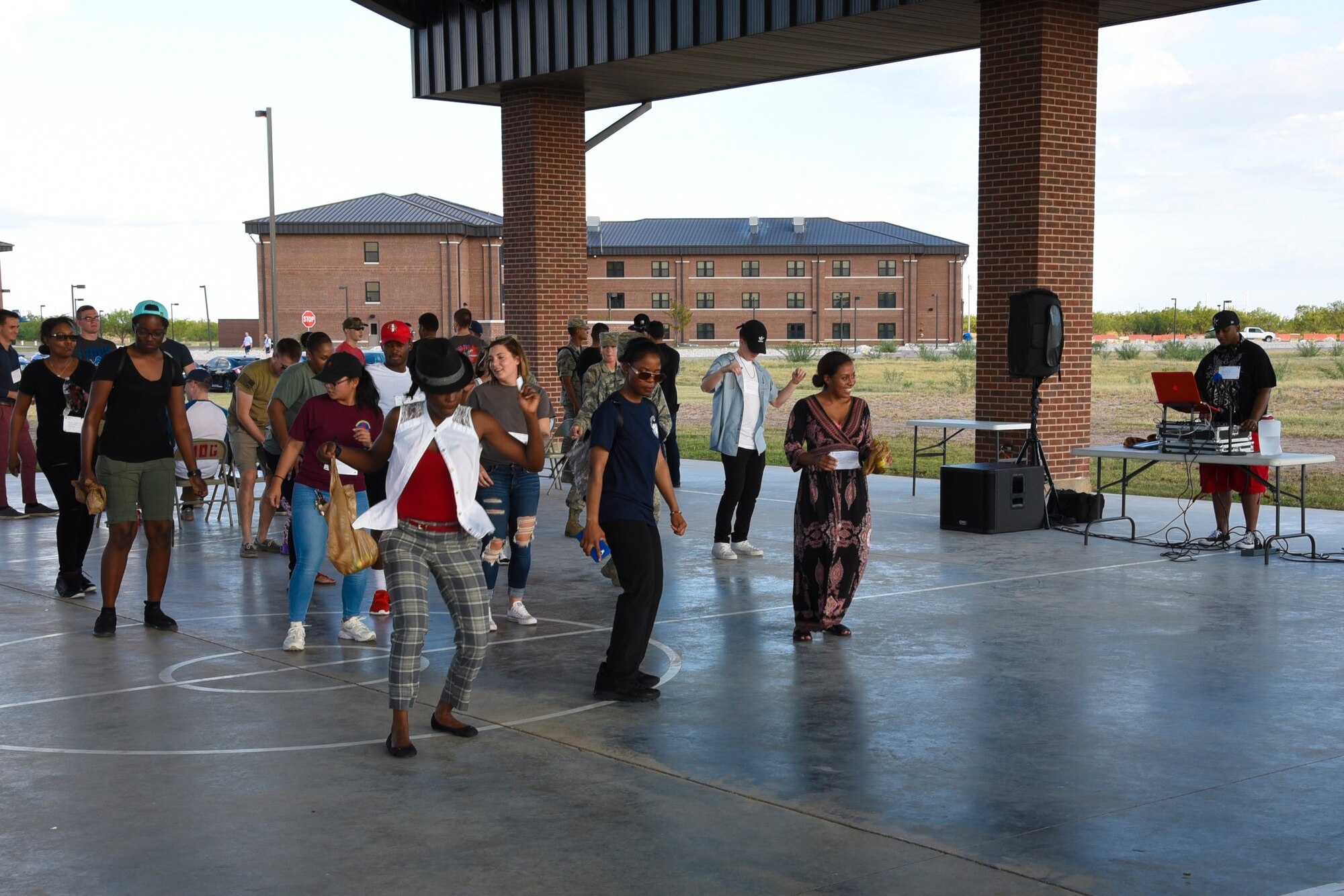 Airmen dance to music provided during the event to dye for at the marching pad on Goodfellow Air Force Base, Texas, Sept. 22, 2017. Along with the music there was free food, a chance to tie-dye and later in the evening an outdoor movie which was all free to those attending. (U.S. Air Force photo by Airman Zachary Chapman/Released)