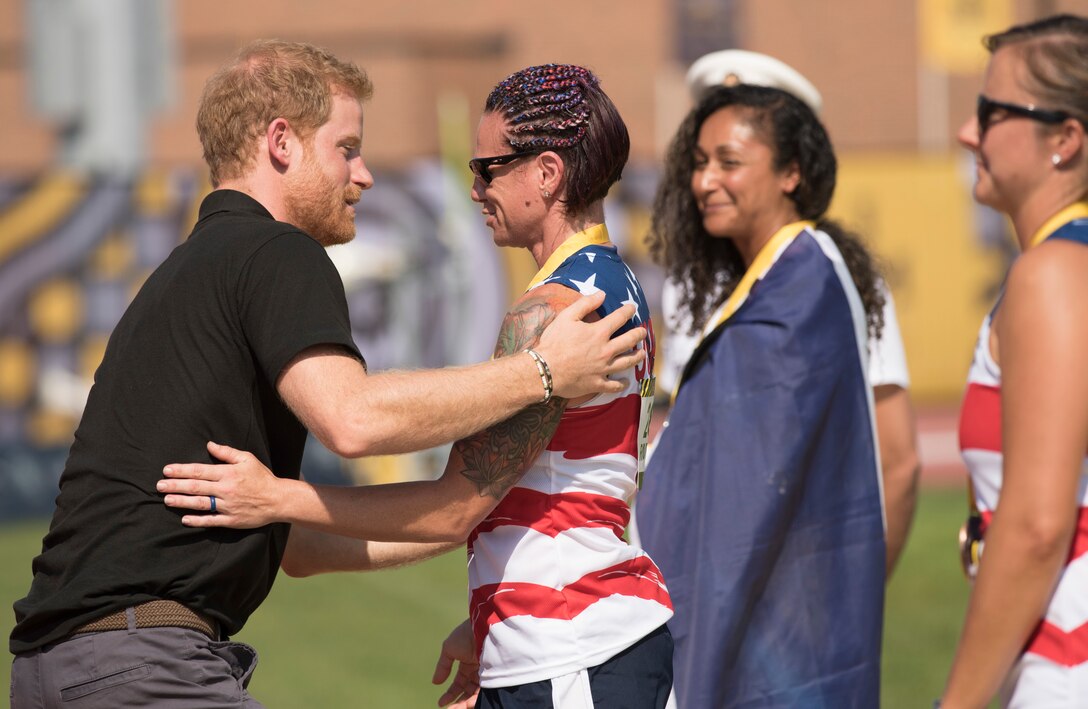 Prince Harry hugs Marine Corps veteran Lance Cpl. Sarah Rudder.