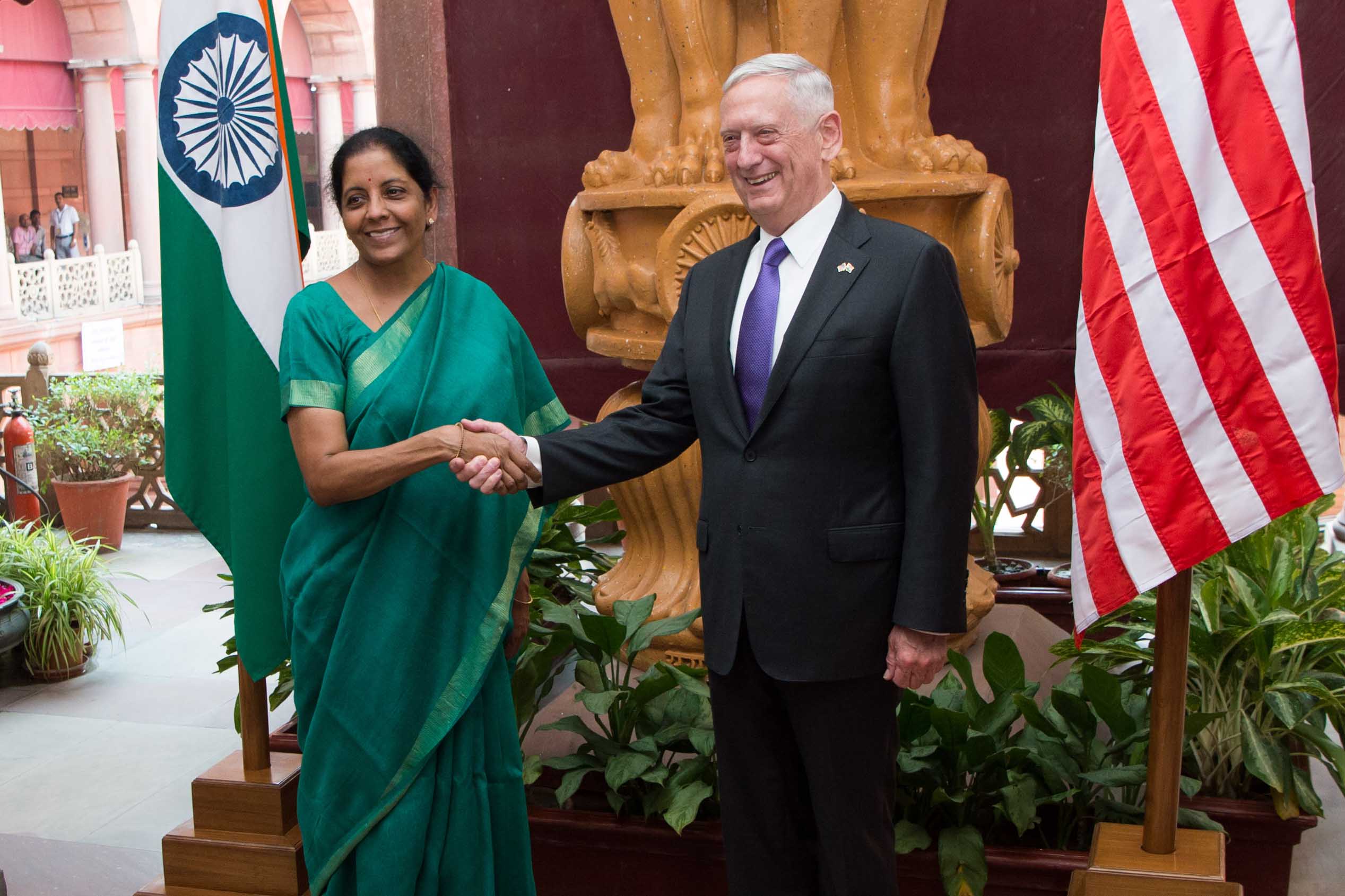 Defense Secretary Jim Mattis shakes hands with Indian defense leader.