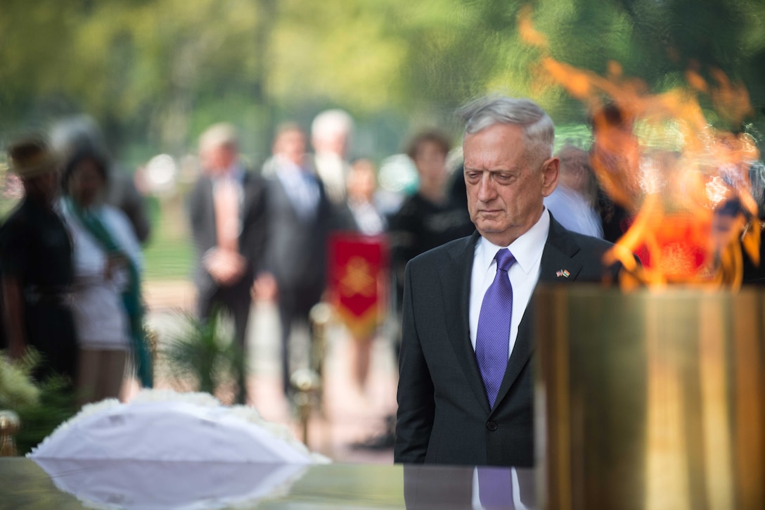 Defense Secretary Jim Mattis pays tribute at a war memorial.