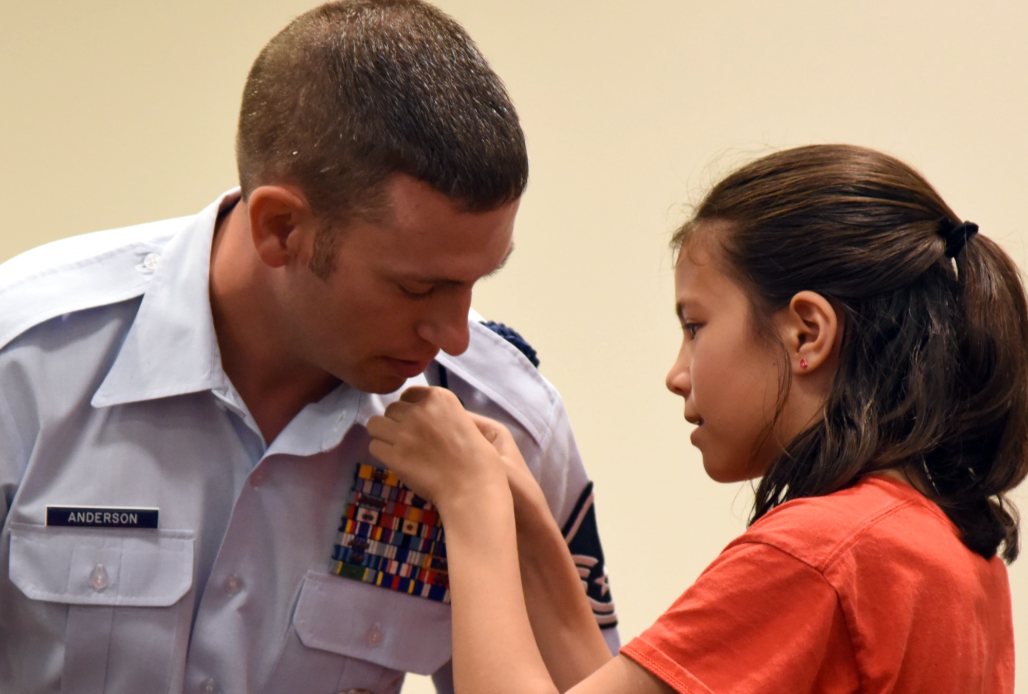 Master Sgt. Joshua Anderson, 81st Training Support Squadron Military Training Leader School instructor supervisor, is pinned on by his daughter, Caitlyn, during the Center for Naval Aviation Technical Training Unit Keesler Chief Petty Officer Pinning Ceremony at the Roberts Consolidated Aircraft Maintenance Facility Sept. 1, 2017, on Keesler Air Force Base, Mississippi. The six-week long Navy Chief Petty Officer Courses held at Keesler and the Naval Construction Battalion Center in Gulfport, Mississippi included four Air Force members, which is the first time Keesler Air Force members have gone through this process. The course is meant to enhance leadership skills and to strengthen the Navy-Air Force enlisted leadership relationship on Keesler. (U.S. Air Force photo by Kemberly Groue)