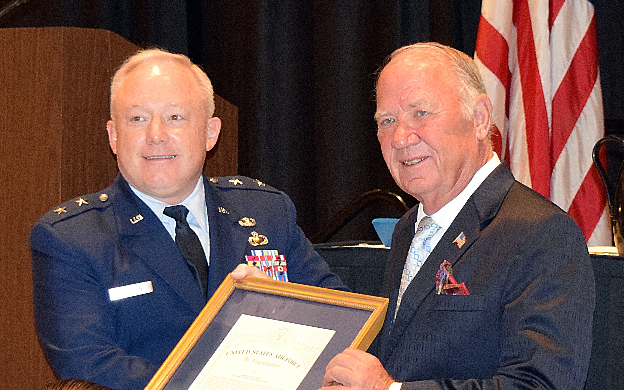 Maj. Gen. Scott Jansson, Air Force Nuclear Weapons Center commander, left, presented Sherman McCorkle, Kirtland Partnership Committee vice chair, with the Air Force Scroll of Appreciation.