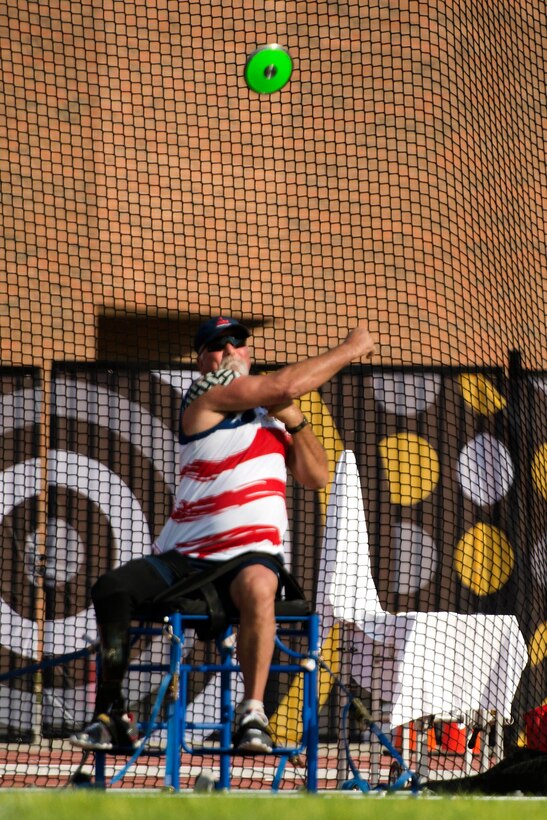 Master Chief Petty Officer James Wilson competes in the men's seated discus throw.