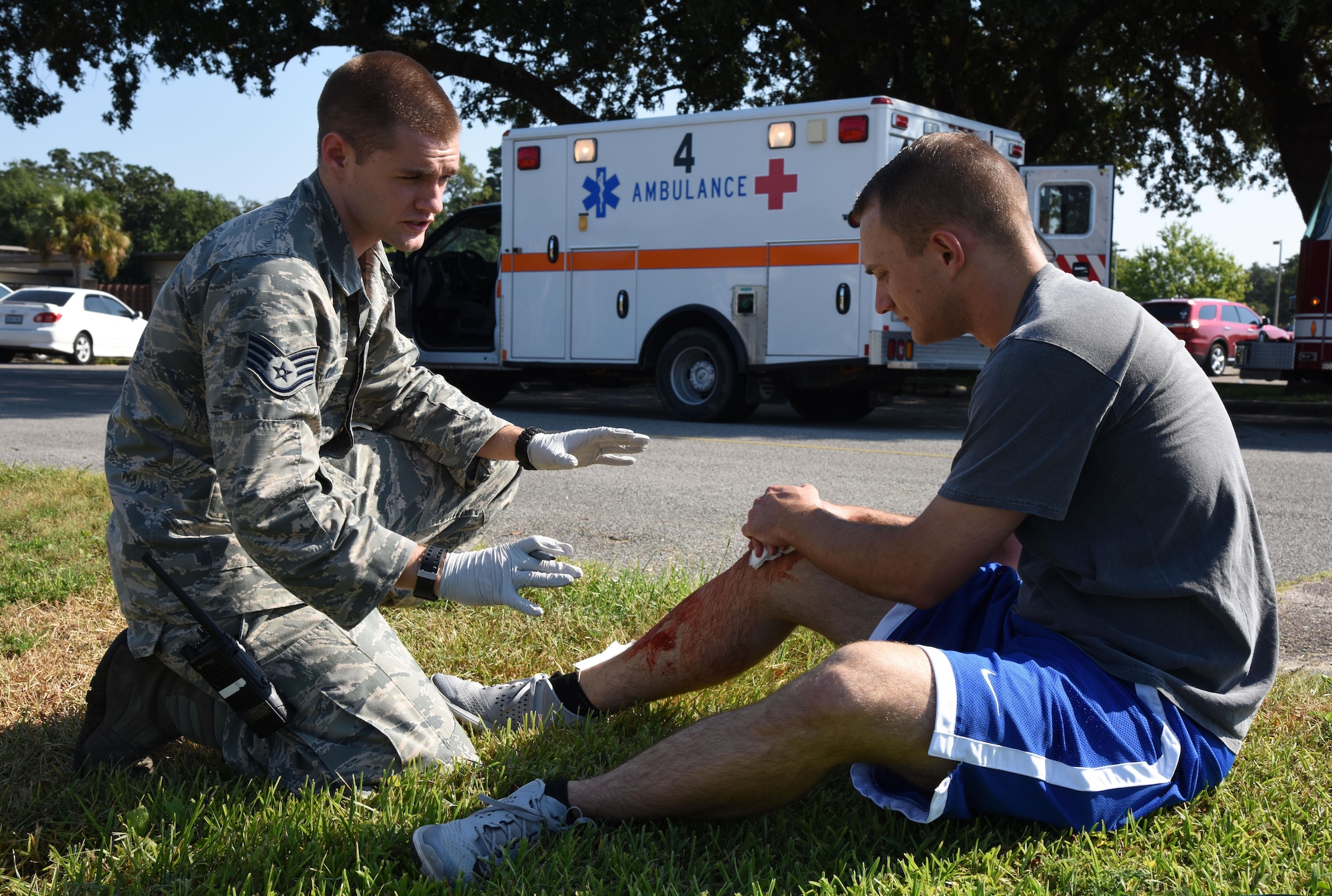 Staff Sgt. Terry Durbin Jr., 81st Medical Operations Squadron emergency services medical technician, medically assesses Airman 1st Class Jonathan Ryden, 336th Training Squadron student, who portrays a victim during an active shooter exercise outside of the Arnold Medical Annex Sept. 21, 2017, on Keesler Air Force Base, Mississippi. An active duty Air Force member simulated opening fire at the Arnold Medical Annex and the Larcher Chapel in order to test the base's ability to respond to and recover from a mass casualty event. (U.S. Air Force photo by Kemberly Groue)