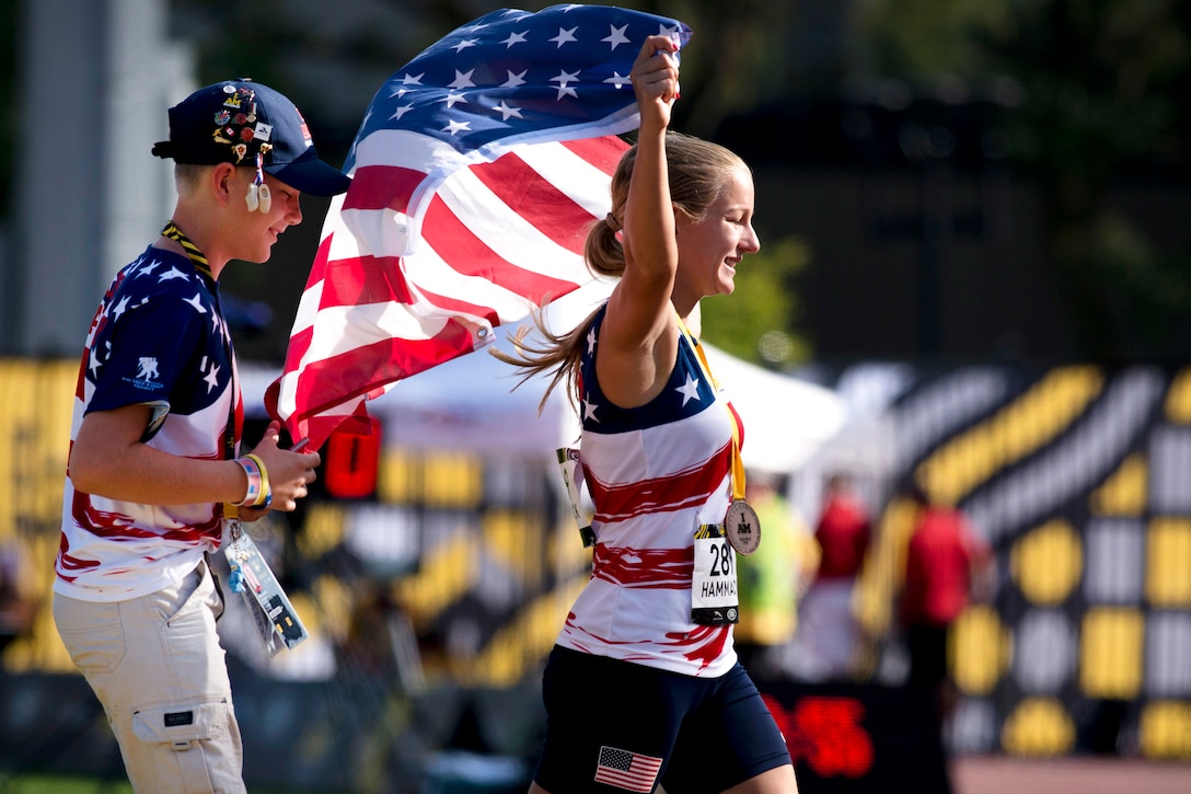Marine Corps veteran Cpl. Jessica-Rose Hammack celebrates after receiving a bronze medal during the finals of track and field.