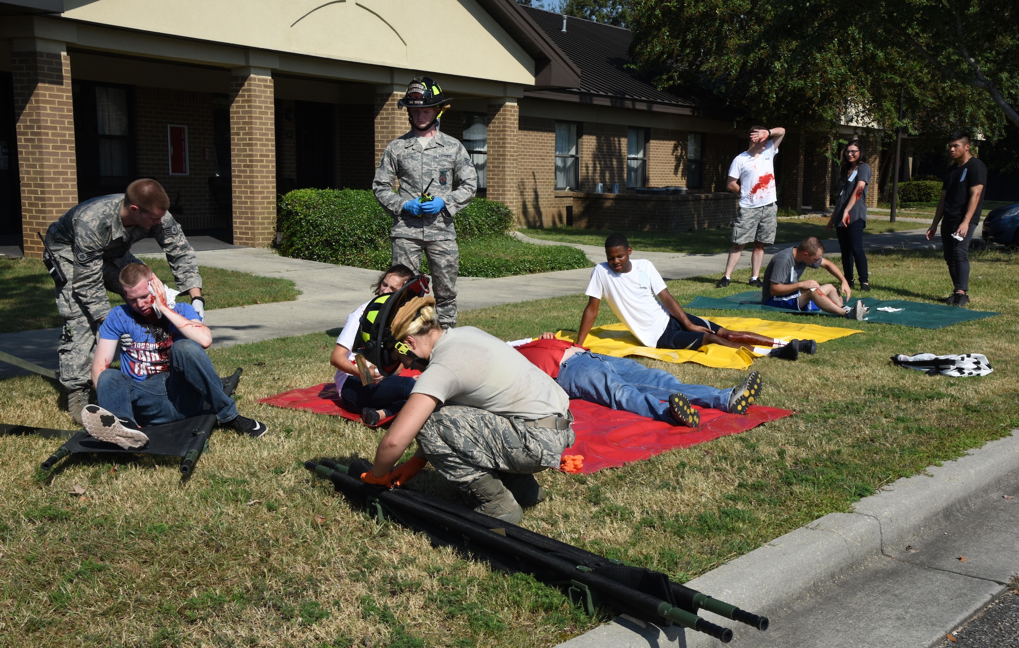 Keesler first responders medically assess actors portraying victims during an active shooter exercise outside of the Arnold Medical Annex Sept. 21, 2017, on Keesler Air Force Base, Mississippi. An active duty Air Force member simulated opening fire at the Arnold Medical Annex and the Larcher Chapel in order to test the base's ability to respond to and recover from a mass casualty event. (U.S. Air Force photo by Kemberly Groue)