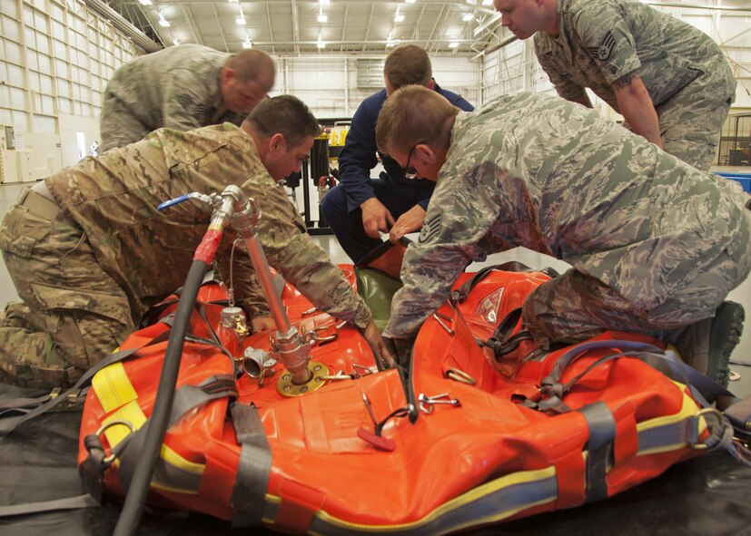 Maintainers from the 919th and 592nd Special Operations Maintenance Squadrons inspect the inner and outer fuel bladders on a cold bulk fuel delivery system
