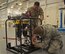Maintainers from the 919th and 592nd Special Operations Maintenance Squadrons inspect an FB-014 fuel filter/water separator