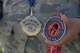 Staff Sgt. Teresa Monteon, 60th Medical Group training manager from San Jose, Calif., displays some of her Reebok Spartan Race medals outside David Grant USAF Medical Center at Travis Air Force Base, Calif., Sept. 22. After a five month battle with cancer, Monteon completed three Spartan races. She plans on running her fourth Spartan race on Sept. 30 in Olympic Valley, Calif. (U.S. Air Force photo by Tech. Sgt. James Hodgman)