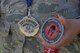 Staff Sgt. Teresa Monteon, 60th Medical Group training manager from San Jose, Calif., displays some of her Reebok Spartan Race medals outside David Grant USAF Medical Center at Travis Air Force Base, Calif., Sept. 22. After a five month battle with cancer, Monteon completed three Spartan races. She plans on running her fourth Spartan race on Sept. 30 in Olympic Valley, Calif. (U.S. Air Force photo by Tech. Sgt. James Hodgman)