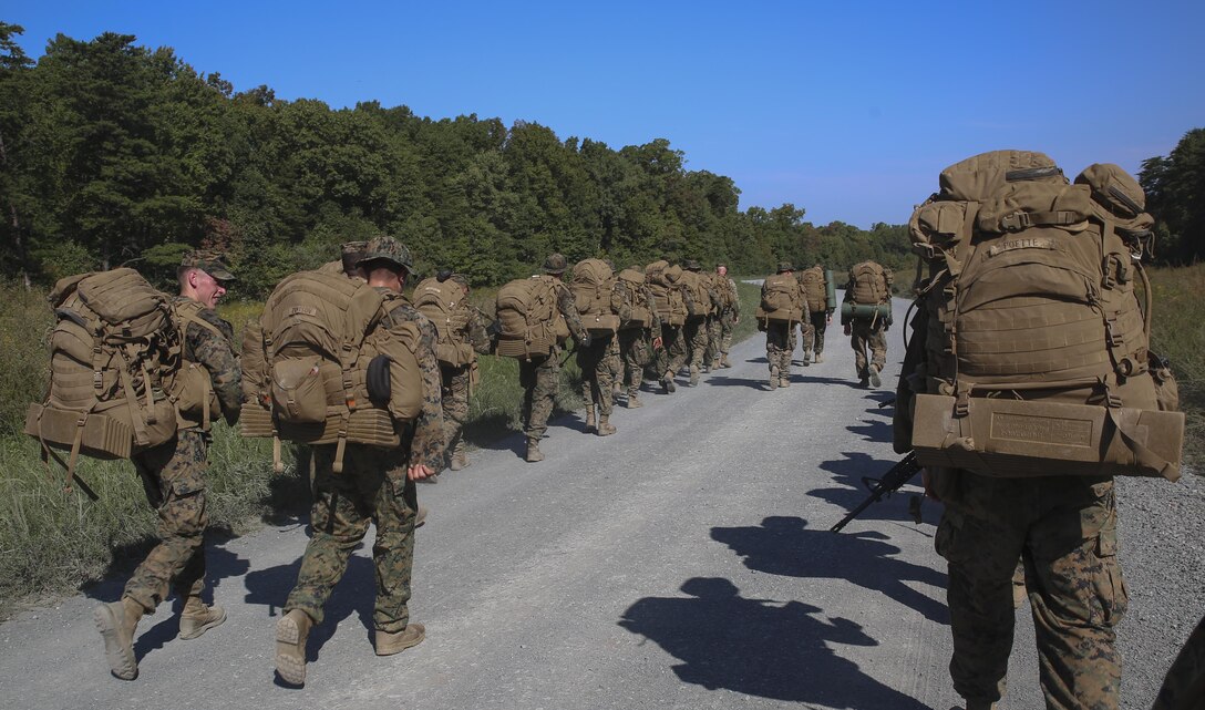 Marines with Marine Barracks Washington D.C. hike with their rucks during the Fire Team Leaders Course at Marine Corps Base Quantico, Va., Sept. 21, 2017. This is the third iteration of the course which is designed to refine the Marines’ infantry skills and strengthen their small unit leadership to prepare them for the fleet. (Official Marine Corps photo by Lance Cpl. Damon Mclean/Released)