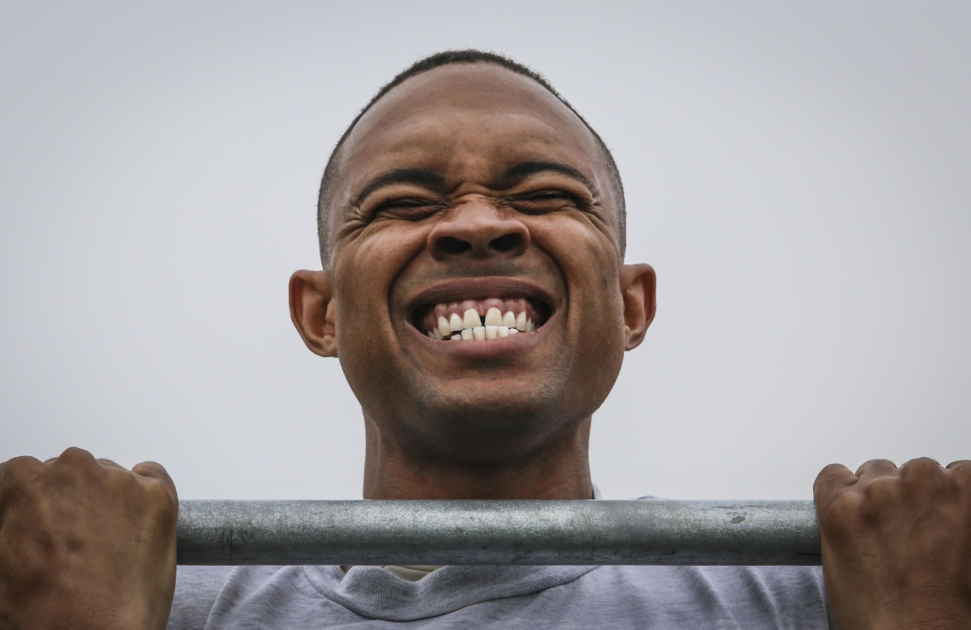 U.S. Air Force Staff Sgt. Garion Reddick fights to hold himself up during the flex arm hang portion of a German Armed Forces Badge for Military Proficiency test at Joint Base McGuire-Dix-Lakehurst, N.J., Sept. 17, 2017. Reddick is assigned to the 108th Maintenance Squadron. (U.S. Air National Guard photo by Master Sgt. Matt Hecht)