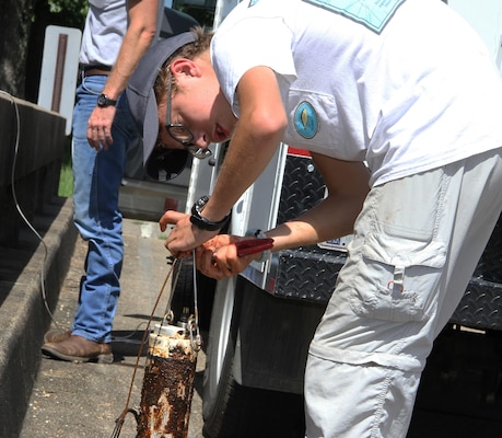 U.S. Army Corps of Engineers, Mobile District Pathways intern Grant Cooper prepares a water-quality sensor at Lake Okatibbee, Miss. this past summer to collect data on the lake’s water quality.