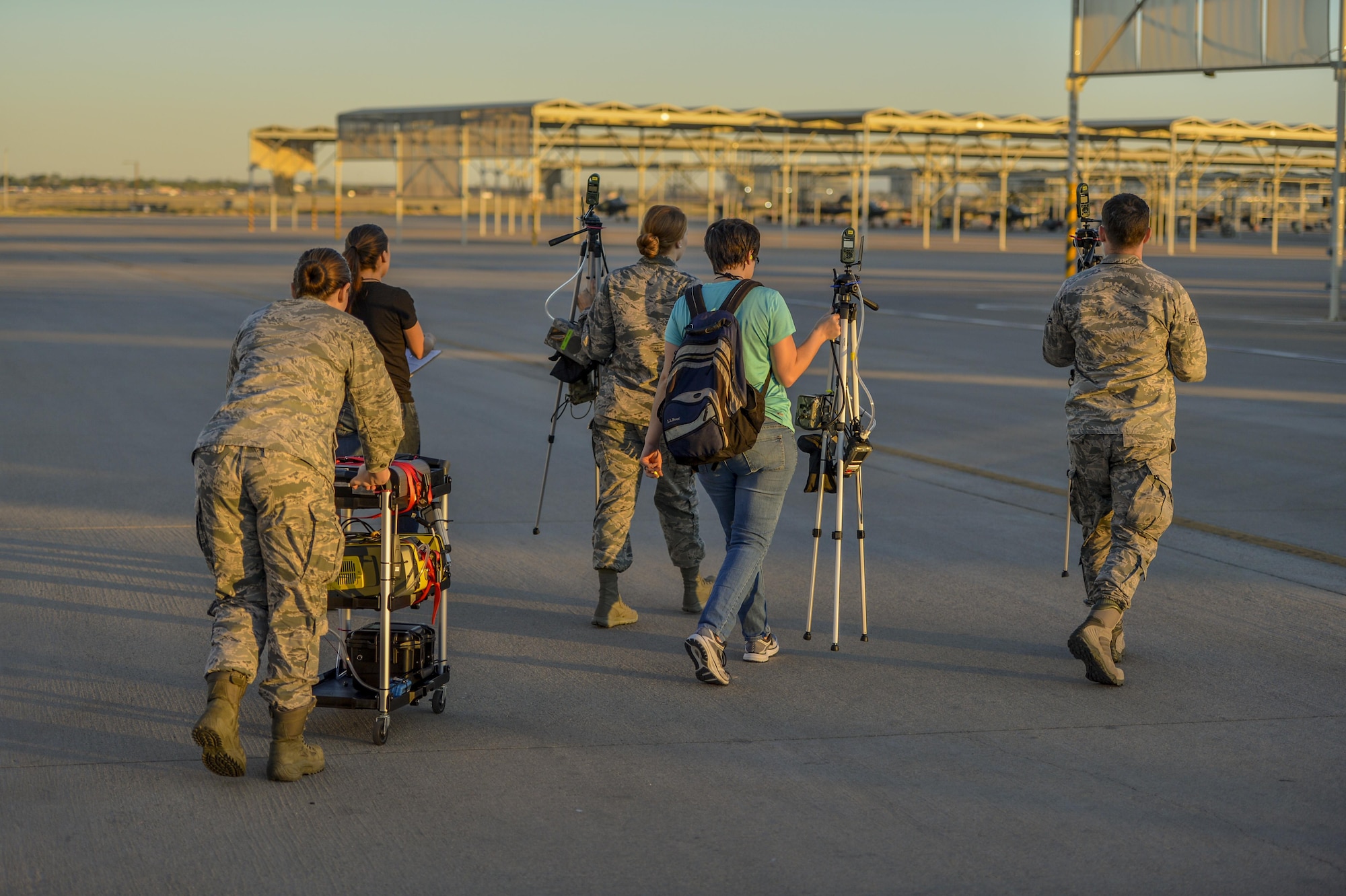 Members of Team Luke and Airmen from the USAF School of Aerospace Medicine relocated equipment on the flightline to perform air quality testing at Luke Air Force Base, Ariz., Sept. 20, 2017. The team members from the USAF School of Aerospace Medicine visited Luke for follow-up testing related to the F-35A Lightning II program. (U.S. Air Force photo/Airman 1st Class Caleb Worpel)