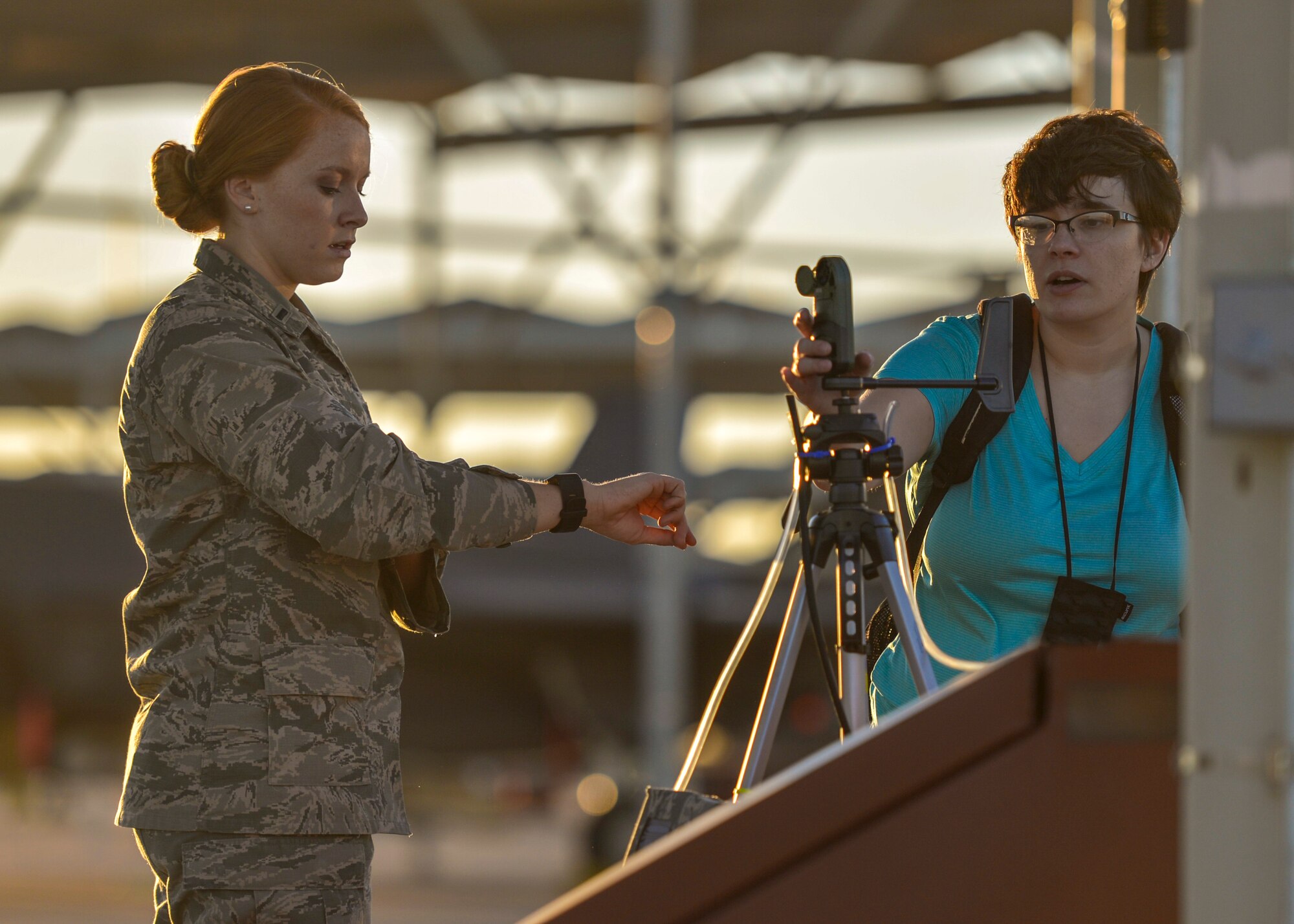 1st Lt. Emilee Senn, F-35 Joint Program Office life support engineer and Megan Steele, USAF School of Aerospace Medicine bioenvironmental engineer, annotate data from a kestrel meter at Luke Air Force Base, Ariz., Sept. 20, 2017. Senn and Steele worked together to record data for the F-35A Lightning II program and potential factors corresponding to the air quality of Luke and the surrounding area.   (U.S. Air Force photo/Airman 1st Class Caleb Worpel)