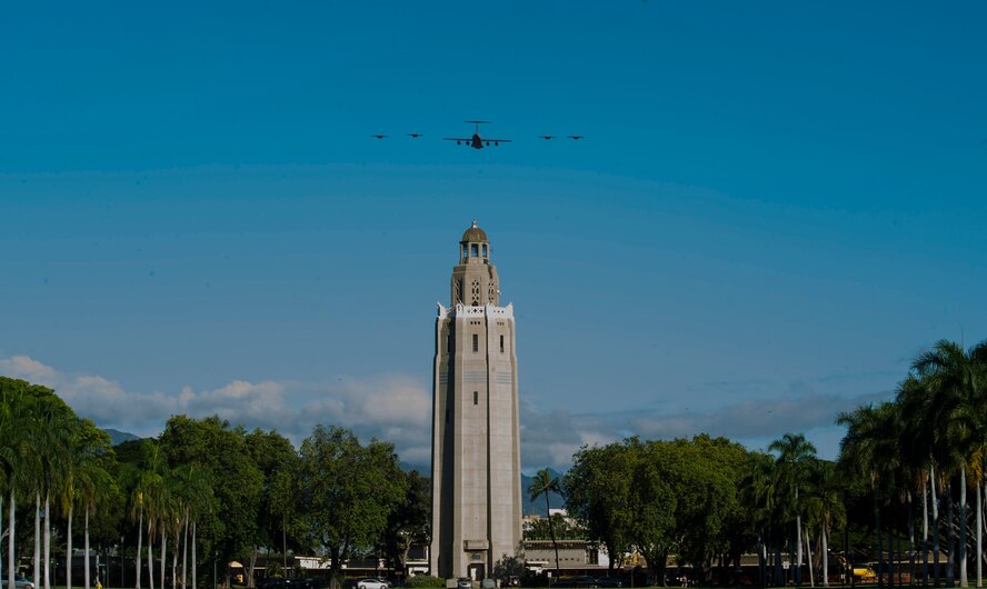 A C-17 Globemaster III and four F-22 Raptors fly in formation over Joint Base Pearl Harbor-Hickam, HI, Sept. 26, 2017.