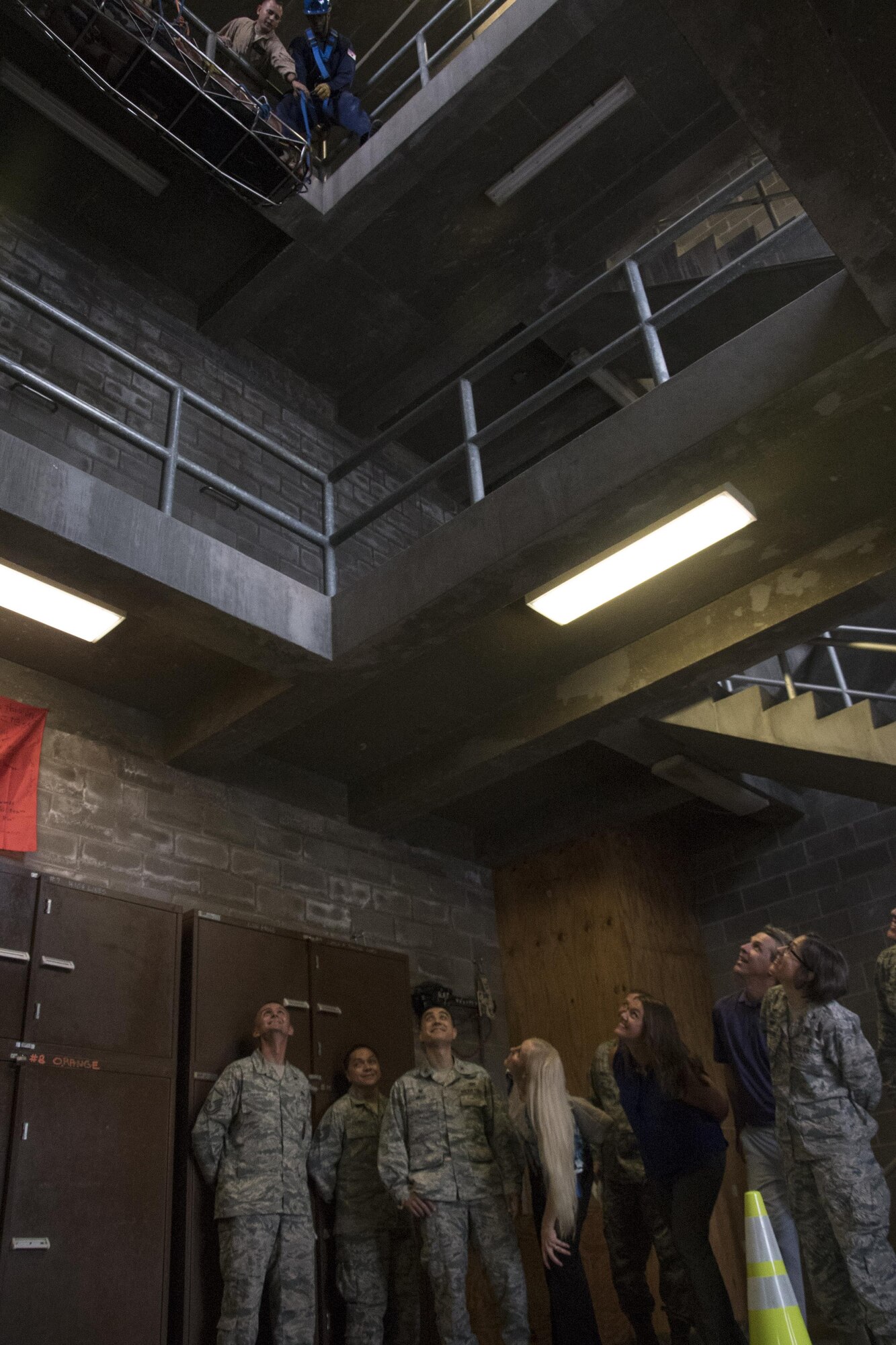 Members of the senior leader’s immersion tour watch as firefighter trainees practice lowering a victim at the Louis F. Garland Department of Defense Fire Academy at Goodfellow Air Force Base, Texas, Sept. 25, 2017. The tour of the fire academy included planes and buildings that are used to train Goodfellow’s future firefighters. (U.S. Air Force photo by Airman Zachary Chapman)