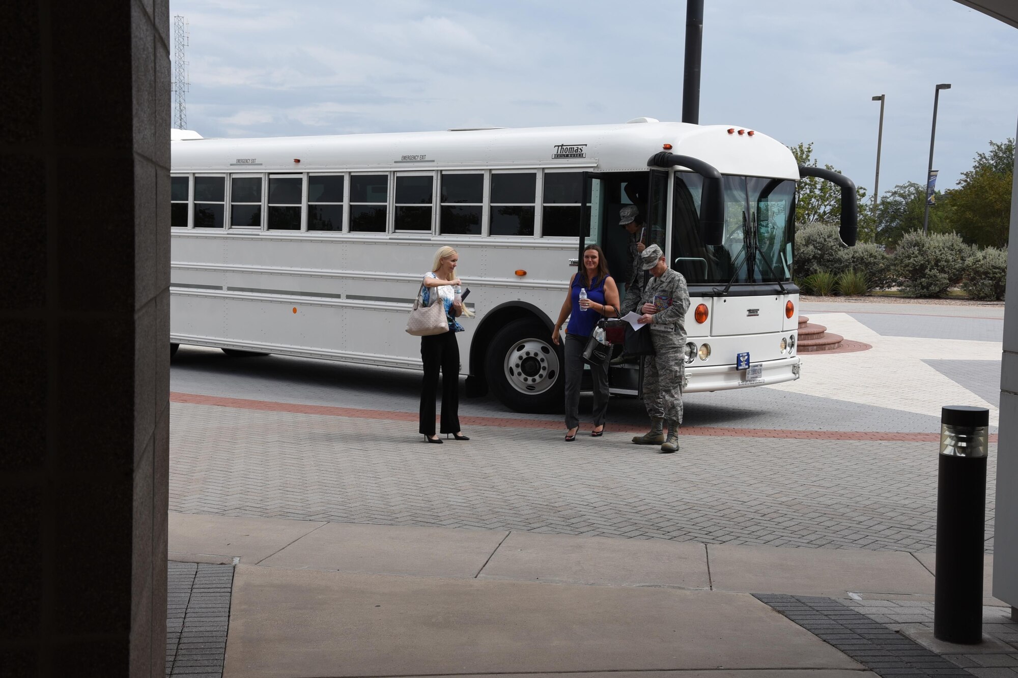 Megan McManus, the 17th Training Wing commander’s wife, Elaine Sorrell, and U.S. Air Force Col. Jeffrey Sorrell, 17th Training Wing vice commander exit the bus at the Norma Brown building on Goodfellow Air Force Base, Texas, Sept. 25, 2017. The Norman Brown building was the final destination of the senior leader’s immersion tour, concluding a visit to many locations showing the base’s mission and operations. (U.S. Air Force photo by Airman Zachary Chapman)