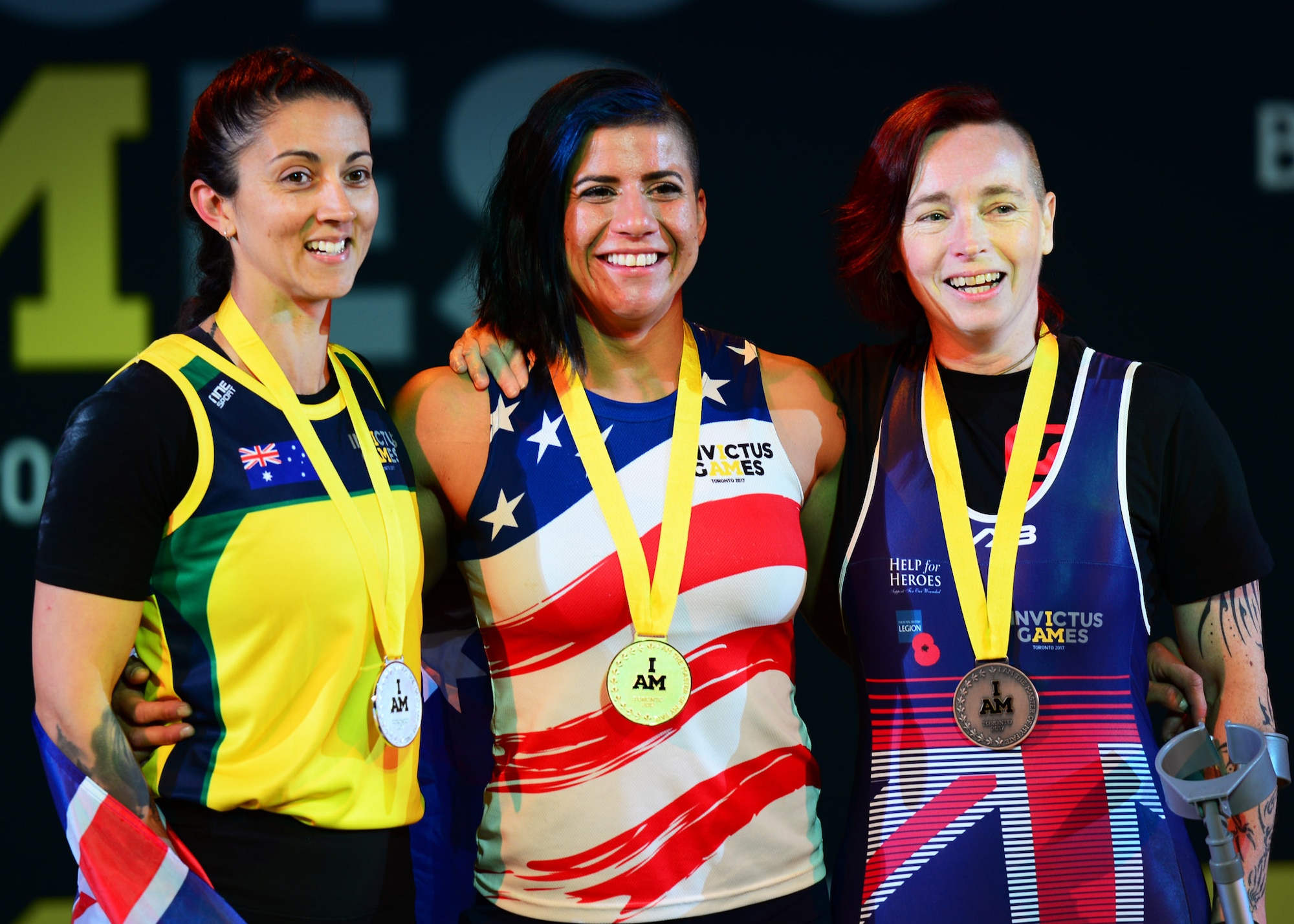 Air Force veteran Sebastiana Lopez, a former C-17 crew chief staff sergeant and member of Team U.S., stands with the silver and bronze medalists following a successful lift during the women’s lightweight powerlifting competition at the Mattamy Sports Centre in Toronto, Canada, Sept. 25, 2017. Lopez claimed gold for the U.S. team during this event as part of the 2017 Invictus Games. (U.S. Air Force photo by Staff Sgt. Chip Pons)