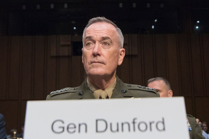 Marine Corps Gen. Joe Dunford sits behind a "Gen Dunford" nameplate.