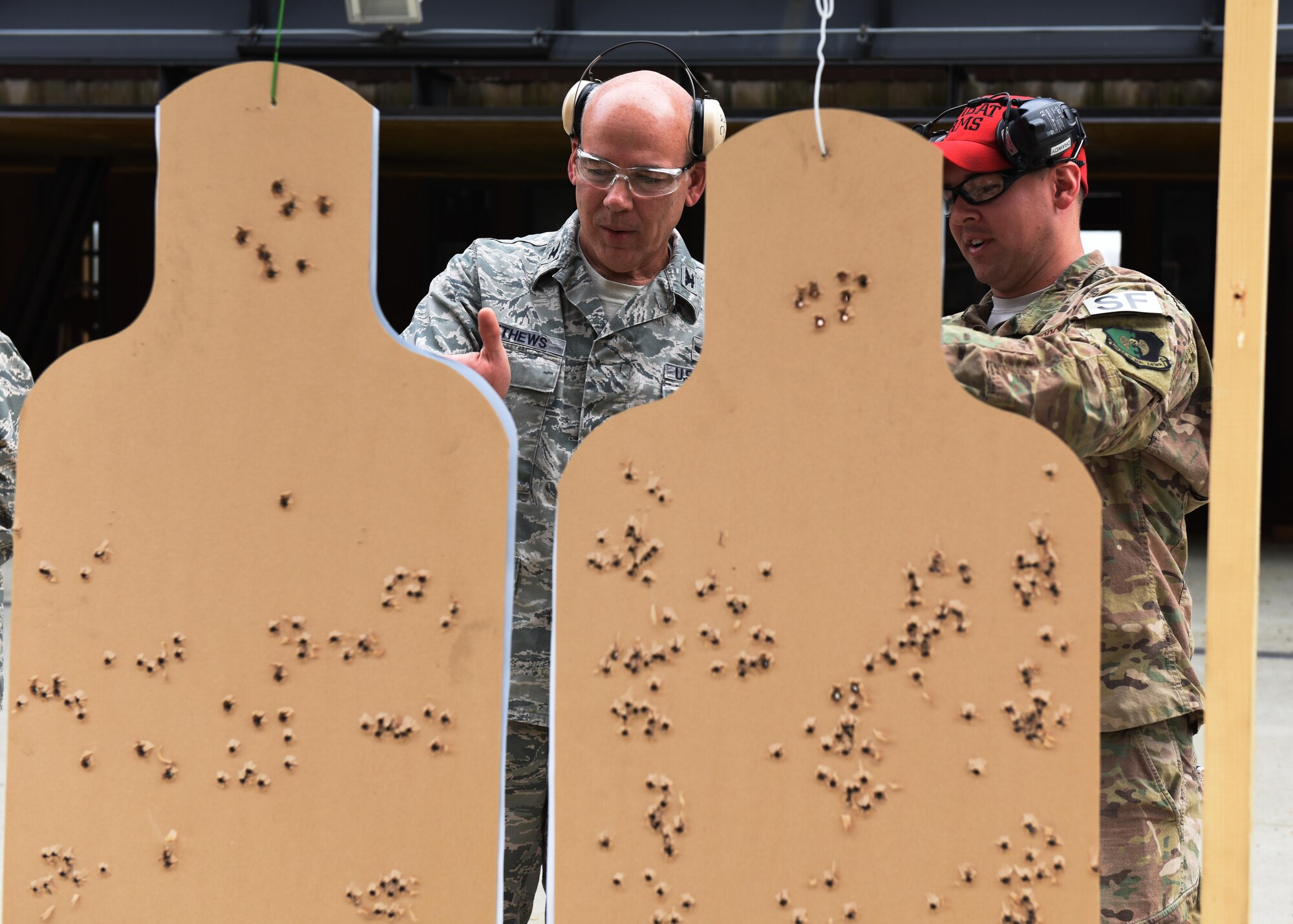 Col. Patrick Matthews, Eighth Air Force vice commander, speaks with a Combat Arms Training and Maintenance instructor during a tour at Minot Air Force Base, N.D., Sept. 25, 2017. During the tour, Matthews visited the 5th Munitions Squadron, CATM, Explosive Ordnance Disposal, Military Working Dogs, 23rd Aircraft Maintenance Unit, and the 5th Operations Support Squadron alert facility.(U.S. Air Force photo by Airman 1st Class Alyssa M. Akers)