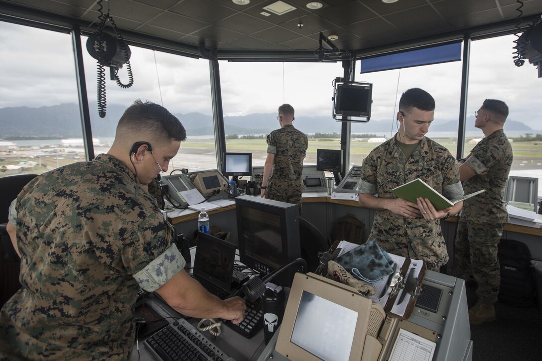 Air traffic controllers with Marine Corps Air Station (MCAS) Kaneohe Bay, conduct operations at the air traffic control tower, MCAS Kaneohe Bay, Sept. 20, 2017. Air traffic controllers work to safely organize and regulate the flow of air traffic, and prevent collisions between aircraft. (U.S. Marine Corps photo by Lance Cpl. Isabelo Tabanguil)