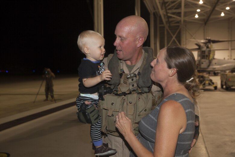 Maj. Timmy Keech, the executive officer of Marine Medium Tiltrotor Squadron (VMM) 268, nicknamed the “Red Dragons,” holds his family after completing a trans-Pacific flight from Australia, Marine Corps Base Hawaii (MCBH), Sept. 19, 2017. The “Red Dragons” supported the Australian Defence Force as the aviation combat element for the Marine Air-Ground Task Force (MAGTF) with Marine Rotational Force Darwin (MRF-D), Australia. These are the first Trans-Pacific flights the MV-22 Ospreys have conducted from Hawaii to Australia. This movement demonstrates that the unfueled range of our MV-22s combined with our refueling capabilities allow us to reach across the entire Pacific Ocean. The U.S. Marine Corps can get it's aircraft and personnel to a crisis on the other side of the world in a matter of days. (U.S. Marine Corps photo by Cpl. Jesus Sepulveda Torres)