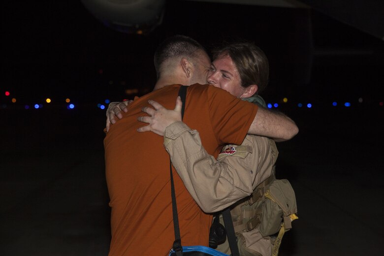 Capt. Ashley Myers, an aircraft commander with Marine Medium Tiltrotor Squadron (VMM) 268, nicknamed the “Red Dragons,” hugs a loved one after completing a trans-Pacific flight from Australia, Marine Corps Base Hawaii (MCBH), Sept. 19, 2017. The “Red Dragons” supported the Australian Defence Force as the aviation combat element for the Marine Air-Ground Task Force (MAGTF) with Marine Rotational Force Darwin (MRF-D), Australia. These are the first Trans-Pacific flights the MV-22 Ospreys have conducted from Hawaii to Australia. This movement demonstrates that the unfueled range of our MV-22s combined with our refueling capabilities allow us to reach across the entire Pacific Ocean. The U.S. Marine Corps can get it's aircraft and personnel to a crisis on the other side of the world in a matter of days. (U.S. Marine Corps photo by Cpl. Jesus Sepulveda Torres)