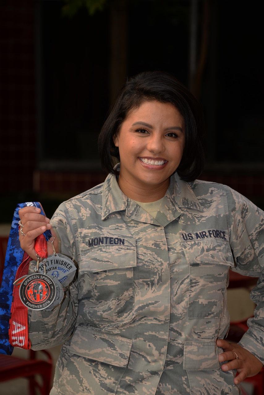 Staff Sgt. Teresa Monteon, 60th Medical Group training manager from San Jose, Calif., poses for a photo with her Reebok Spartan Race medals outside David Grant USAF Medical Center at Travis Air Force Base, Calif., Sept. 22. After a five month battle with cancer, Monteon completed three Spartan races. She plans on running her fourth Spartan race on Sept. 30 in Olympic Valley, Calif. (U.S. Air Force photo by Tech. Sgt. James Hodgman)