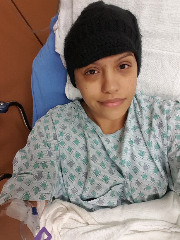Staff Sgt. Teresa Monteon, 60th Medical Group training manager from San Jose, Calif., sits in her hospital bed during a nine-day hospitalization at David Grant USAF Medical Center in December 2016. Monteon was diagnosed with Hodgkin’s Lymphoma and is now in remission after undergoing four months of chemotherapy and one month of proton therapy. (Courtesy Photo)