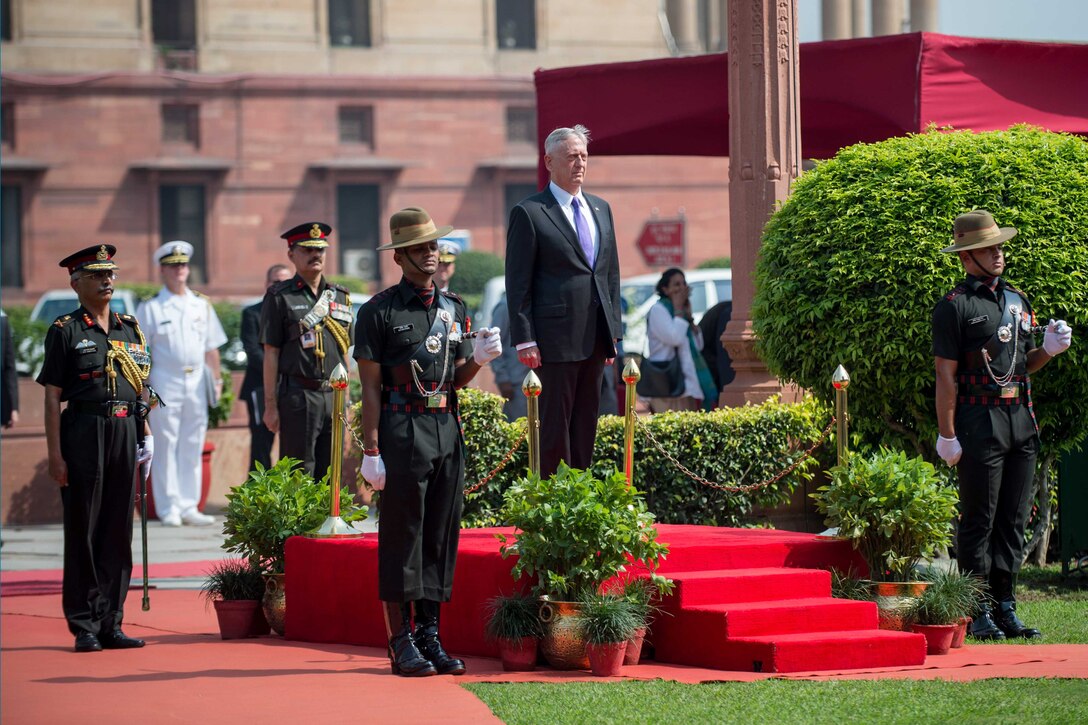 Defense Secretary Jim Mattis stands at attention.